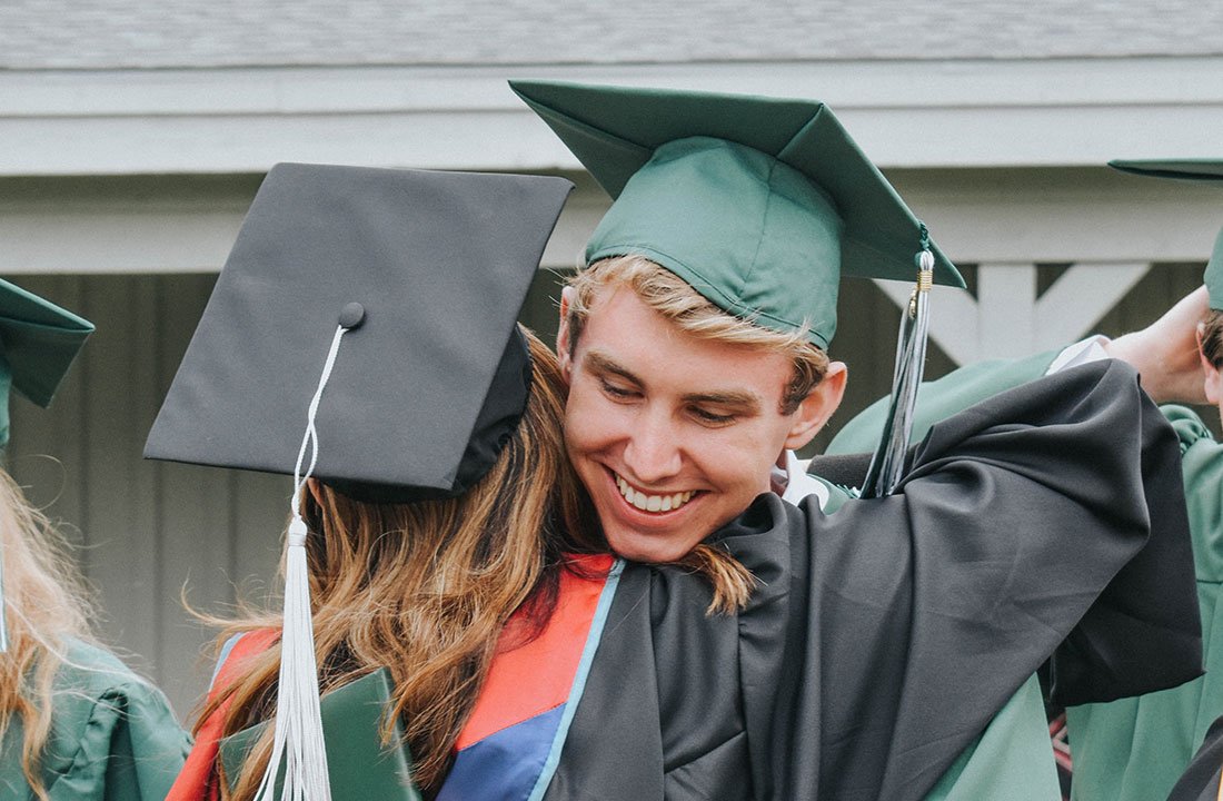 student hugging teacher at graduation