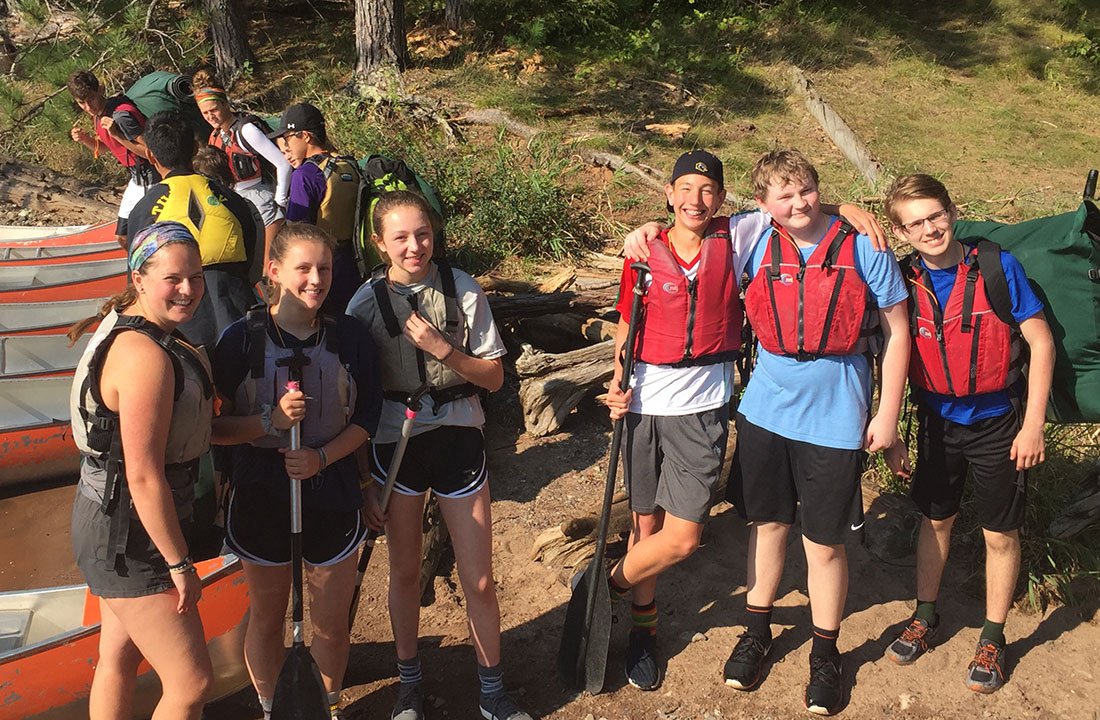 students posing in life vests